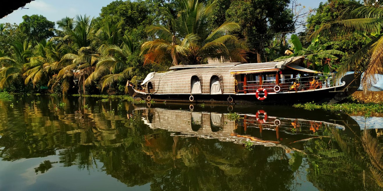 A houseboat on a palm-lined Kerala backwater